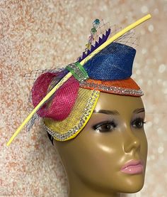 This Yellow, blue, green, pink, and orange multicolor double disc Sinamay fascinator is trimmed with veil netting, feather stem, sinamay bows, rhinestones and hat pin. The hat pin may vary and is for decorative purposes only. The hat measures approximately 9.5 by 4.5 inches. The hat affixes to the head by a hat elastic/string. Handmade SHIPPING All items for free shipping will be shipped via USPS FIRST CLASS MAIL. Adjustable Multicolor Party Costume Hat, Adjustable Multicolor Costume Hats For Parties, Elegant Multicolor Headband For Party, Adjustable Multicolor Headband For Party, Elegant Multicolor Party Headband, Multicolor Mardi Gras Party Costume Hats And Headpieces, Multicolor Costume Hats For Mardi Gras Party, Whimsical Multicolor Headband For Summer, Adjustable Multicolor Costume Headband