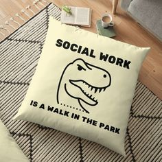 a square pillow with the words social work is a walk in the park on it