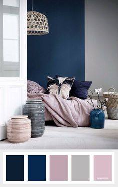 a bedroom with blue walls and white furniture, including a pink blanket on the bed