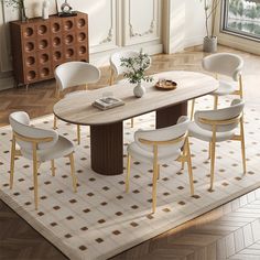 a dining room table with white chairs and a rug on the floor next to it