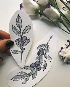 someone is showing off their instagram stickers with flowers and leaves on the back