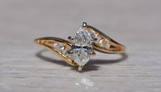 an engagement ring with two pear shaped diamonds