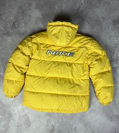 Nike Vintage Down Puffer Jacket Big Swoosh Logo Y2K 90s Drill Excellent used condition, without any defects, after dry clean! PLEASE CHECK MEASUREMENTS!! pit2 pit: 21'2" inches \ 54 cm length on the back: 27'5" inches \ 70 cm from shoulder to the end of sleeve: 23'6" inches \ 60 cm shoulders: 20'4" inches \ 52 cm If u have any questions please contact me before purchase 90s Puffer Jacket, Sportswear Puffer Jacket For Streetwear, Hooded Sportswear Puffer Jacket For Streetwear, Winter Sportswear Puffer Jacket For Streetwear, Hooded Puffer Jacket For Streetwear In Sporty Style, Yellow Winter Streetwear Outerwear, Yellow Winter Outerwear For Streetwear, Yellow Sportswear Outerwear For Winter, Sporty Yellow Outerwear For Winter