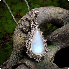 Embrace the enchanting glow of the moon with this stunning Moonstone Necklace Pendant. This timeless piece features a mesmerizing natural moonstone set in elegant sterling silver, perfect for adding a touch of magic to any outfit. Known for its mystical qualities, the moonstone is believed to enhance intuition, inspire creativity, and bring calmness to those who wear it. Whether you're a lover of boho-chic jewelry, spiritual healing stones, or simply drawn to the captivating beauty of the moon, this moonstone pendant necklace will elevate your style and spirit. Each pendant is crafted with care, showcasing the moonstone's natural luminescence and delicate rainbow flashes. Its versatile design makes it an ideal gift for birthdays, anniversaries, or anyone who appreciates fine gemstone jewel Spiritual Silver Moonstone Necklace, Mystical Moonstone Round Pendant Jewelry, Spiritual Moonstone Pendant Jewelry, Spiritual Moonstone Pendant Necklace, Spiritual Moonstone Nickel-free Necklace, Healing Stones Necklace, Fairy Pendant, Moonstone Pendant Necklace, Boho Chic Jewelry