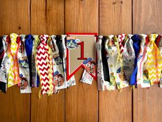 there are many different colored ties hanging on the clothes line with numbers one and two