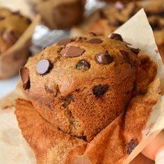 chocolate chip muffins sitting on top of parchment paper