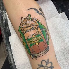 a tattoo on the arm of a person with a beer