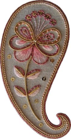 an embroidered paisley with pink flowers on it