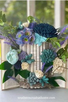 an open book decorated with flowers and books