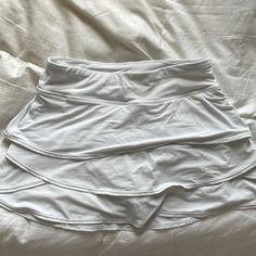 Super Soft And Flowy White Stretch Tiered Skirt, Sporty Fitted Tiered Skirt Skort, Fitted Sporty Tiered Skort, Sporty Fitted Tiered Skort, Sporty Tiered Skirt For Spring, Sporty Tiered Skirt For Summer, White Stretch Tiered Tennis Skirt, White Tiered Stretch Tennis Skirt, White Stretch Tennis Skirt For Sports