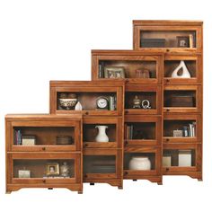 four wooden shelves with books and vases on them