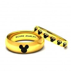 two gold rings with mickey mouse heads on them, one has a name engraved on it