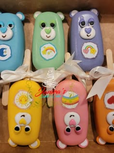 five different colored bear shaped soaps in a box