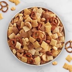 a bowl filled with cheetos and pretzels on top of a table