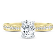 a yellow and white diamond engagement ring with channeled diamonds on the band, set in 18k gold