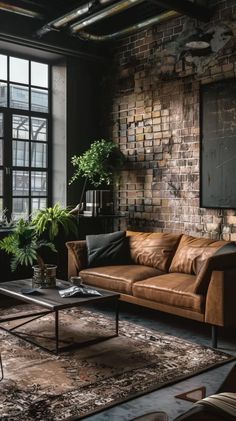 a living room filled with lots of furniture next to a brick wall and large windows