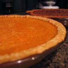 two pies sitting on top of each other in pans