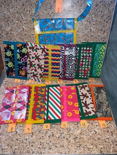 several different colored ties laid out on a counter top with numbers for each one in front of them