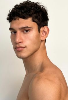 a young man with no shirt on posing for the camera