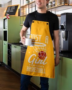 a man in an apron is holding a cup