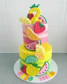 a multi layer cake with fruit on top