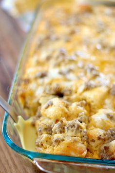 a casserole dish with meat and cheese in it on a wooden table top