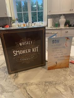 the whiskey smoker kit is sitting on the kitchen counter next to it's box