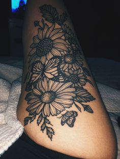 a woman's thigh with flowers on it