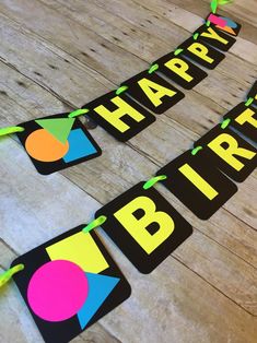 happy birthday banner on wooden floor with green streamers