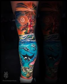 this is an image of a man's leg with dolphins and lighthouses on it