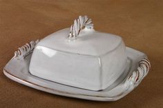 a white porcelain dish with rope handles