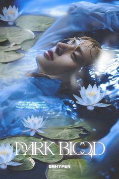 a woman is floating in the water with lily pads