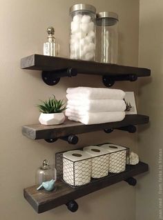 bathroom shelves with towels, soaps and other items on them in a home setting