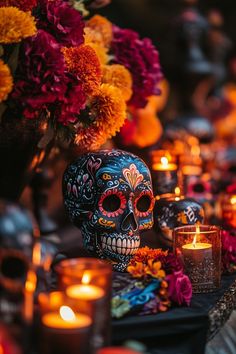 a table topped with lots of candles and skulls covered in sugar skull decorations on top of it