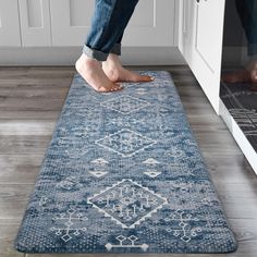 a person standing on top of a blue rug