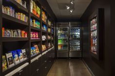 a grocery store filled with lots of food and drink coolers next to each other