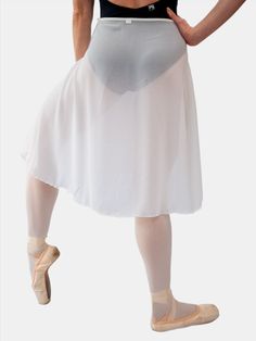 a woman in a white skirt and ballet shoes is standing with her hands on her hips