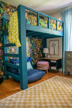 a bunk bed in a child's bedroom with colorful wallpaper