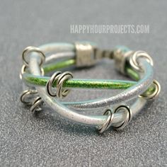 two bracelets with green and white beads on them sitting on a gray table top