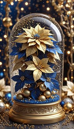 a snow globe with blue and gold flowers under it on a table next to christmas decorations