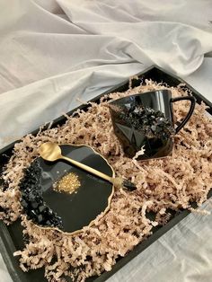 a tray filled with black and gold items