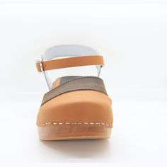 "The Mila is a hand-made adjustable wooden clog sandal, featured in Cognac and Dark Brown Oiled leather combination and adjustable buckle. * Hand-made in Europe * Genuine Oiled leather * Adjustable strap * 2\" / 50mm heel and 1\" / 25mm platform * Genuine Swedish wooden outsole with rocker bottom to propel your foot forward * Wood harvested from sustainable European forests ---> Ships in 1 business day <--- ---> Sizing Conversion EU US Women's EU 35 ---- US 5 EU 36 ---- US 5.5 - 6 EU 37 Adjustable Brown Clogs With Buckle Closure, Brown Clogs For Spring, Medium Width, Brown Summer Clogs With Cork-bed Midsoles, Brown Leather Non-slip Clogs, Brown Clogs With Buckle Closure, Medium Width, Sweden Fashion, Swedish Clogs, Clogs Style, Clog Sandals