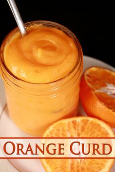 an orange curd is sitting on a plate next to sliced oranges