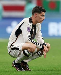 a soccer player kneeling down on the field