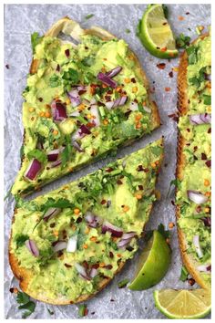 an avocado pizza is cut into slices and garnished with cilantro