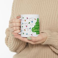 a woman holding a coffee mug with christmas lights all over it's white background