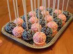 there are many cake pops on the tray