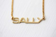 Sally Name Necklace, Sally Necklace, Name Jewelry Gold, Vintage Name Necklace, Name Plate Necklace, Retro Everyday Gold Jewelry, Vintage Silver Name Necklace, Vintage Personalized Nameplate Necklace, Personalized Vintage Nameplate Necklace, Retro Gold Necklace As A Gift, Retro Gold Necklace Gift, Vintage Nameplate Necklaces, Vintage Gold Nameplate Jewelry, Vintage Custom Name Jewelry Nameplate