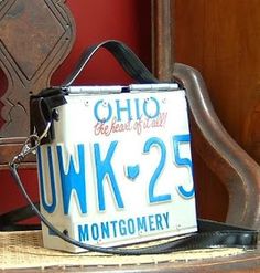 a white and blue sign sitting on top of a wooden chair