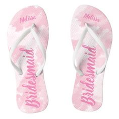 a pair of pink flip flops with the word bride written on them